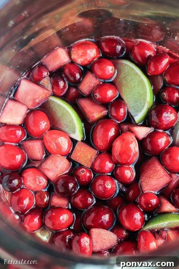 Tangy Cranberry Lime Sangria 5 Cranberry Lime Sangria pitcher with fresh fruit, ready to be served as a holiday cocktail.