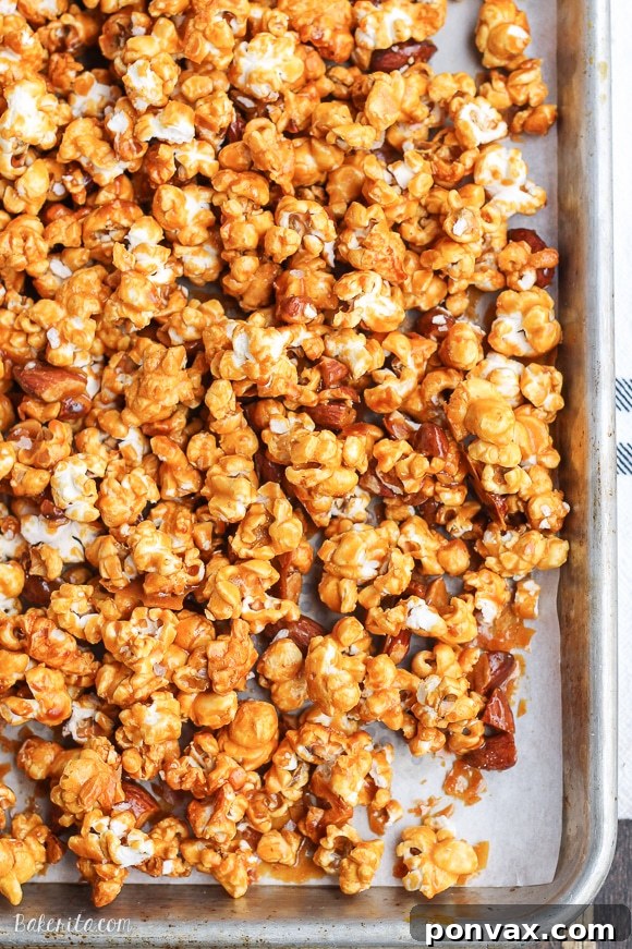 A large bowl filled with freshly baked Salted Honey Almond Caramel Corn.