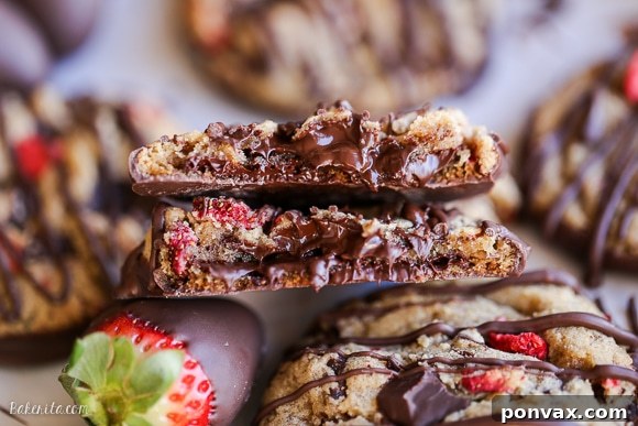 Strawberry Chocolate Indulgence Cookies 3 Close-up of a chocolate-dipped strawberry chocolate chip cookie, showing the texture and chocolate drizzle.