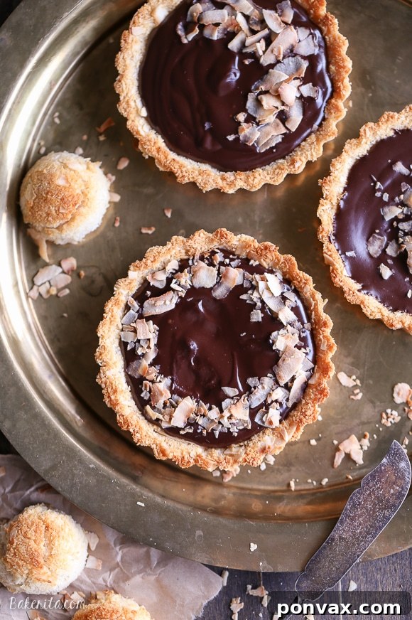 Chocolate Coconut Ganache Dream Tarts 2 Decadent Paleo Chocolate Ganache Tart with Gluten-Free Coconut Macaroon Crust, garnished with toasted flakes