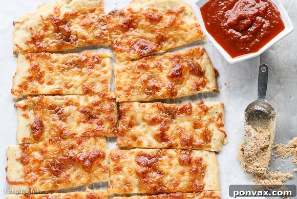 Whimsical Wands 3 Close-up of golden brown Sweet Sticks, featuring melted cheese, minced garlic, and caramelized brown sugar.