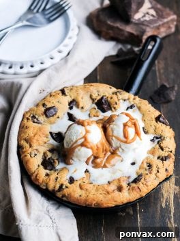 A delicious Peanut Butter Chocolate Chip Skillet Cookie, baked to golden perfection, ready to be served.