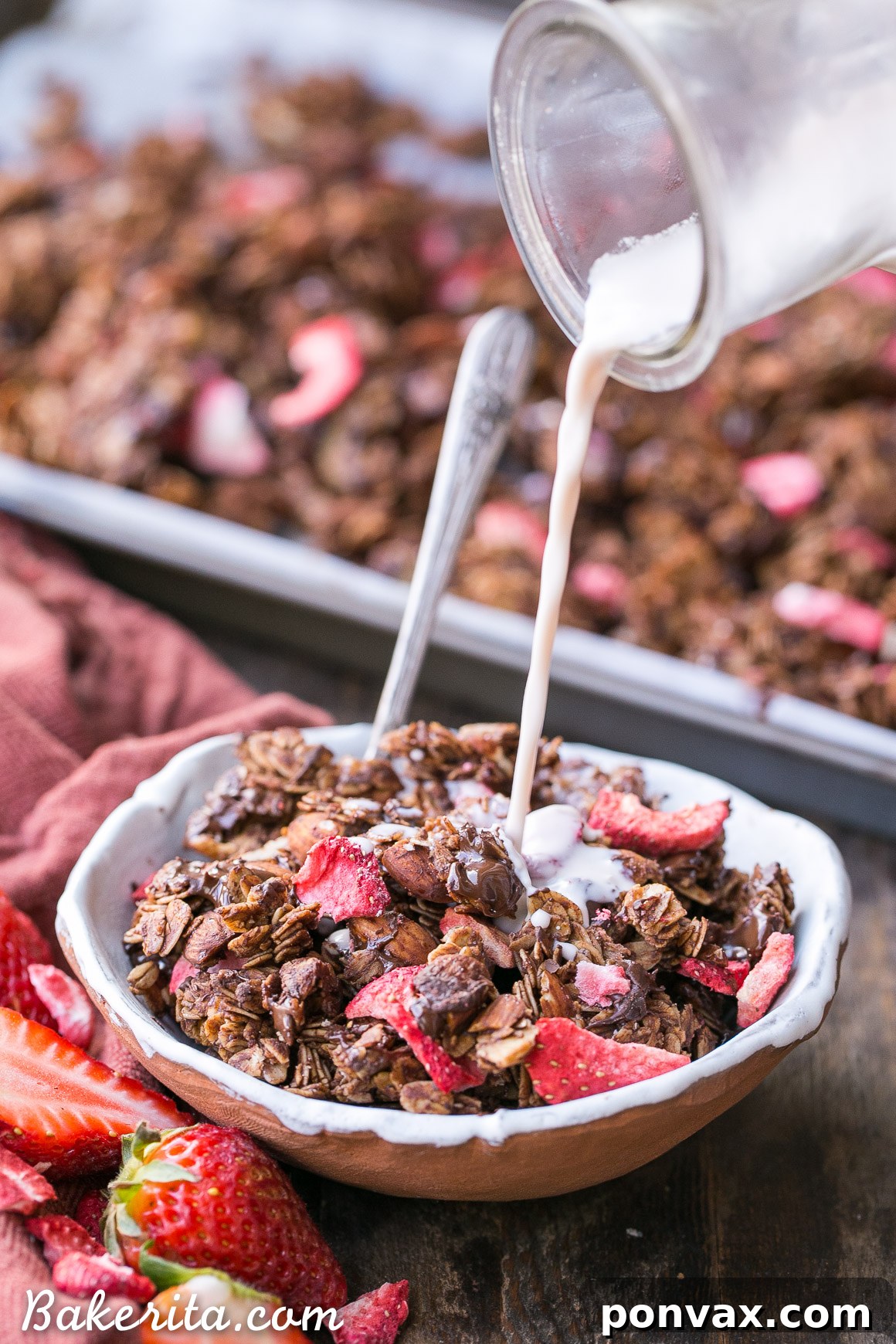 Warm Chocolate Strawberry Granola being stirred with melted chocolate chips