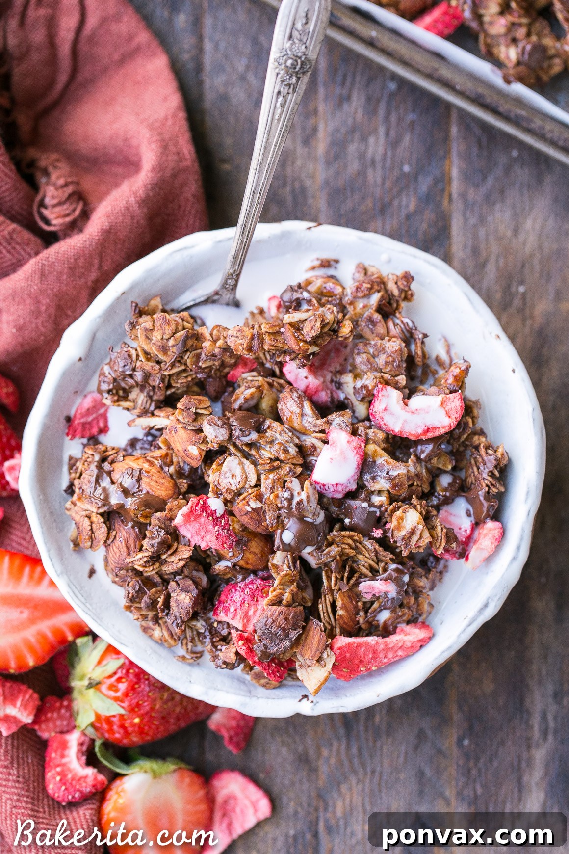 An airtight jar filled with freshly made Chocolate Strawberry Granola