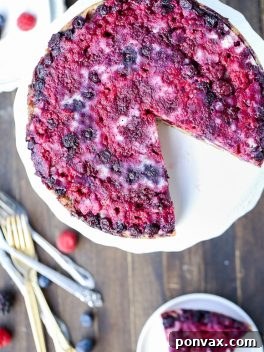 A stunning Berry Upside Down Cake, garnished with fresh mint, ready to be served.