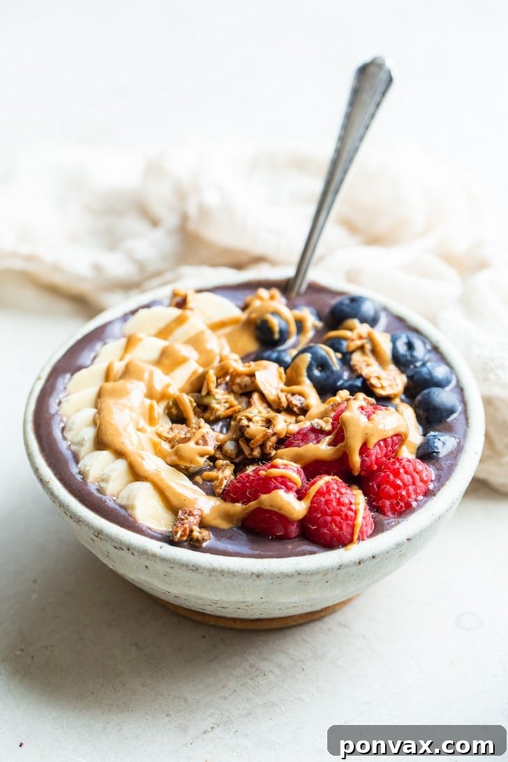 Ingredients for an acai bowl laid out: a frozen acai packet, a frozen banana, and a carton of non-dairy milk.