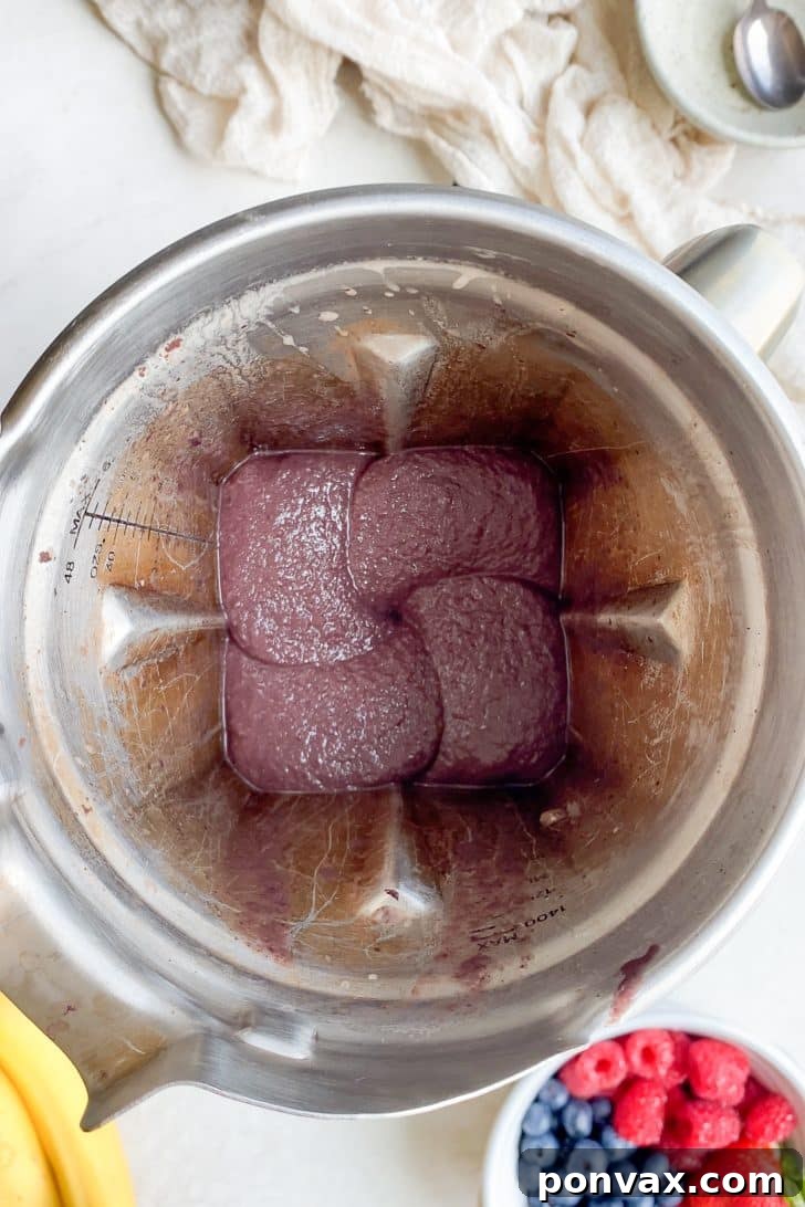 A beautifully decorated acai bowl with fresh fruit and granola, ready to be enjoyed.