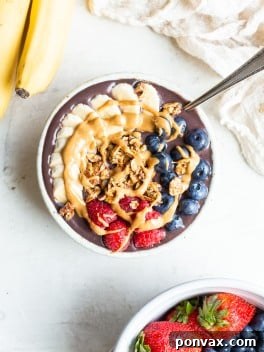 A delicious 5-minute homemade acai bowl with fresh fruit and granola toppings.