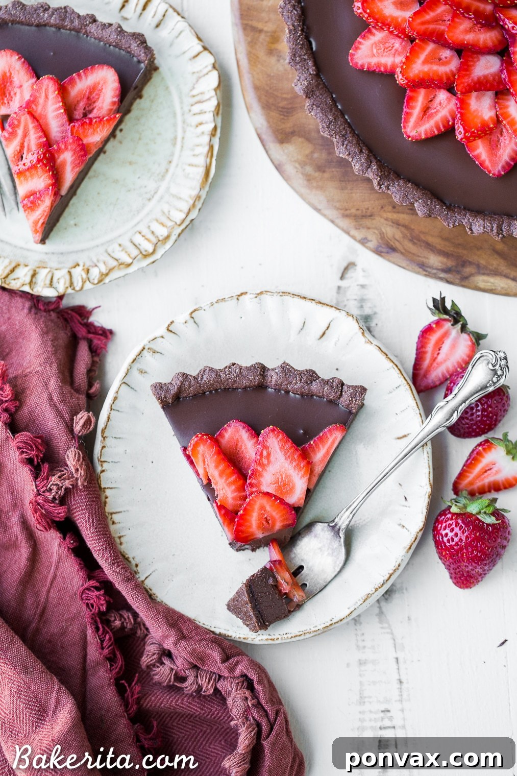This Strawberry Chocolate Tart is filled with vegan chocolate ganache and topped with fresh strawberries, all in a chocolate crust. Slice into this easy and delicious gluten-free, Paleo, and vegan dessert.