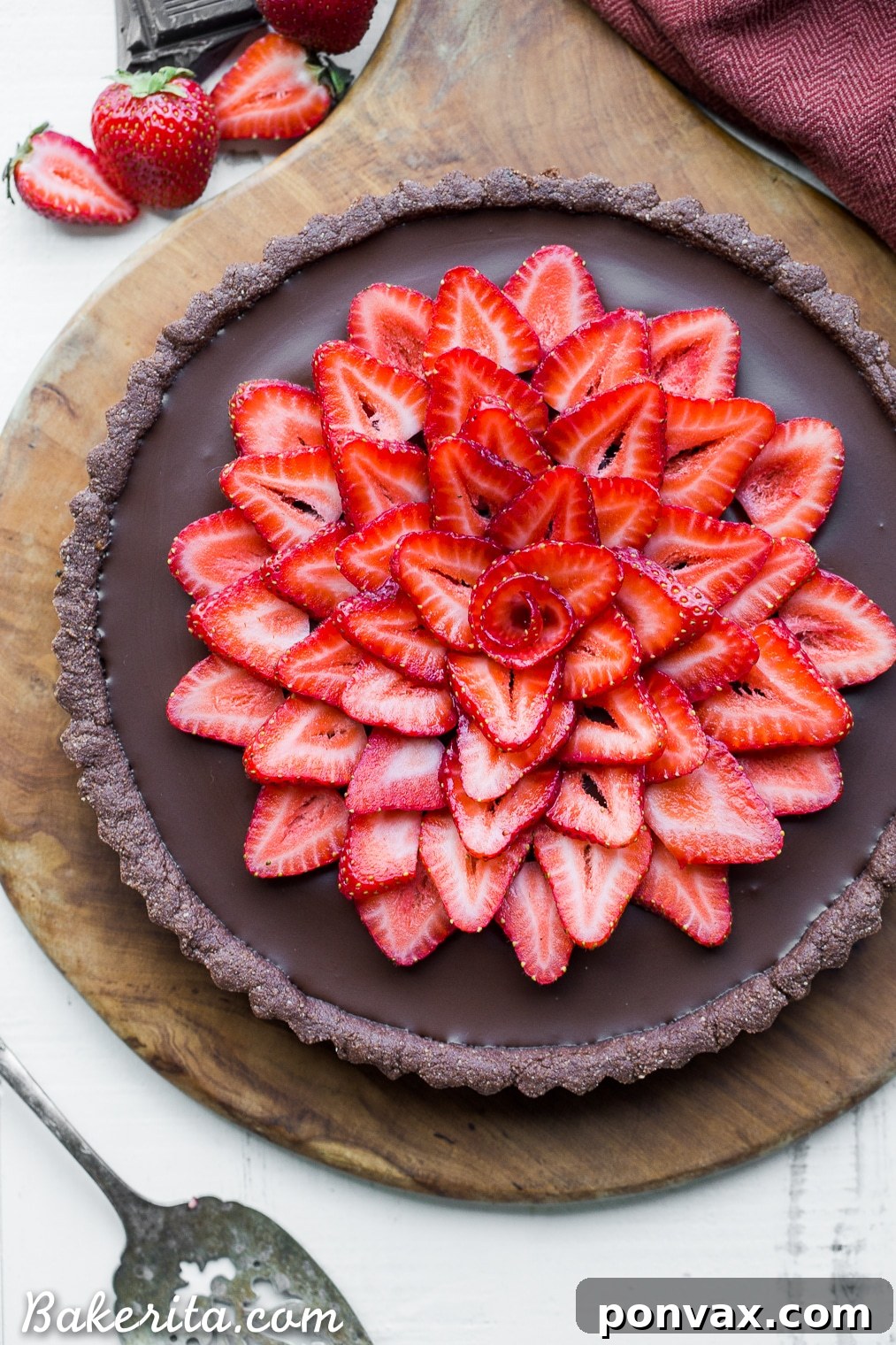 This Strawberry Chocolate Tart is filled with vegan chocolate ganache and topped with fresh strawberries, all in a chocolate crust. Slice into this easy and delicious gluten-free, Paleo, and vegan dessert.