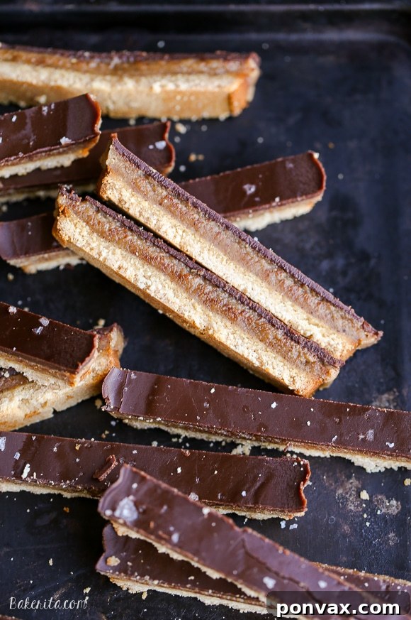 A freshly made batch of homemade Paleo Twix bars with a sprinkle of sea salt on top.