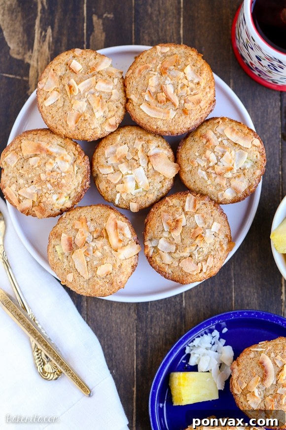 Have a taste of the tropics with these Vegan Pineapple Coconut Muffins! They're super soft, full of tropical flavor, and no one would ever guess that they are dairy-free + vegan.