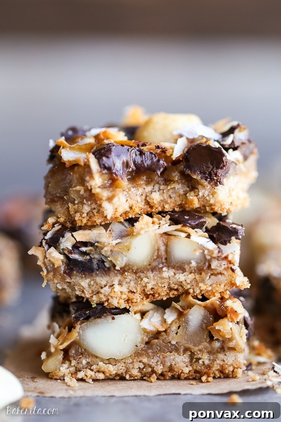 Decadent Dark Chocolate Macadamia Nut Bars Gluten Free Vegan 6 Close-up of a single Dark Chocolate Macadamia Nut Magic Bar, perfectly cut and ready to be enjoyed.