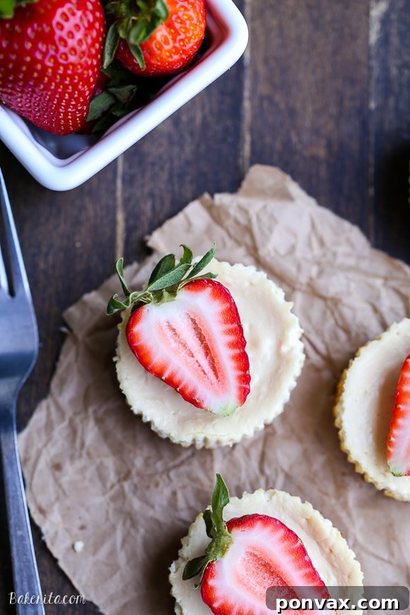 These Greek Yogurt Cheesecakes are smooth and creamy with a bit of tanginess and a crunchy granola crust. These gluten-free cheesecakes were delicious for breakfast topped with fresh berries, and they're only 177 calories each!