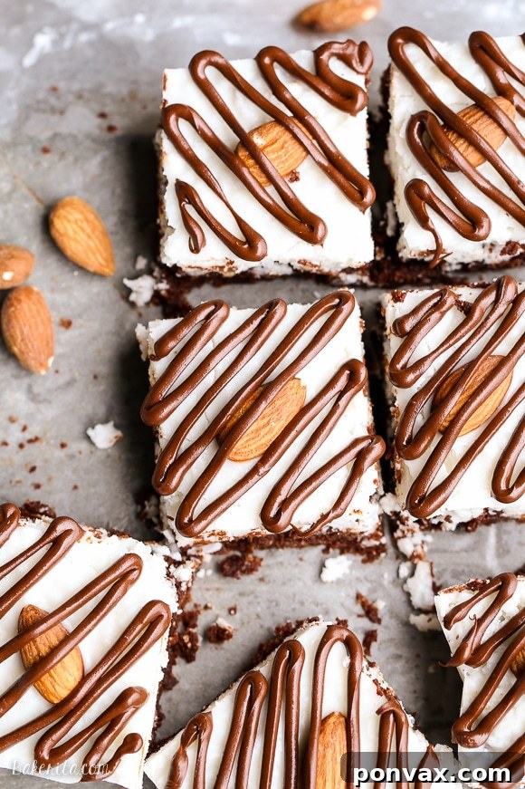 These Almond Joy Brownies feature a decadent coconut butter topping and a rich dark chocolate drizzle, incredibly gluten-free, refined sugar-free, and Paleo-friendly.