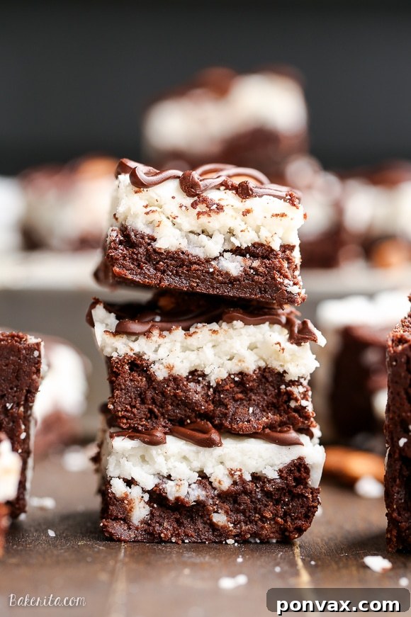 The coconut butter topping on these Almond Joy Brownies provides a luscious, creamy layer, enhancing the gluten-free and Paleo treat.
