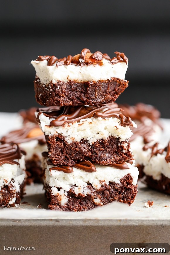 The finished Almond Joy Brownies, topped with almonds and a dark chocolate drizzle, are an irresistible gluten-free, refined sugar-free, and Paleo treat.
