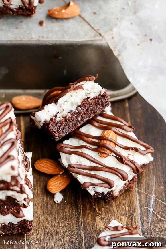 A close-up of the delicious Almond Joy Brownies, showcasing the fudgy texture, coconut topping, and chocolate drizzle, all gluten-free and Paleo.