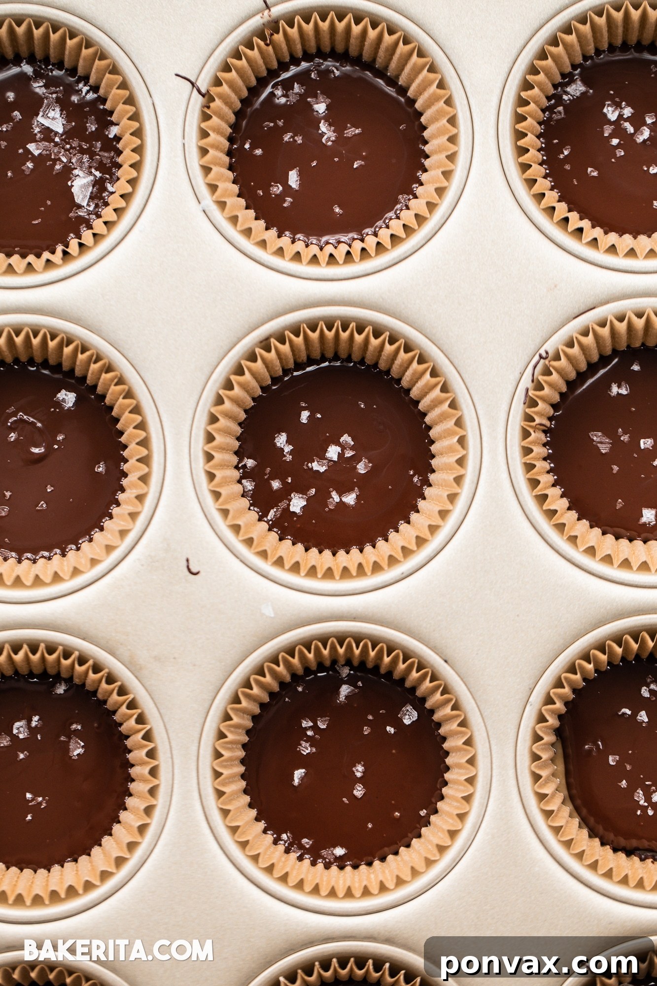 Close-up of a partially eaten Vegan Chocolate Peanut Butter Caramel Cup, revealing the thick, gooey peanut butter caramel layer.