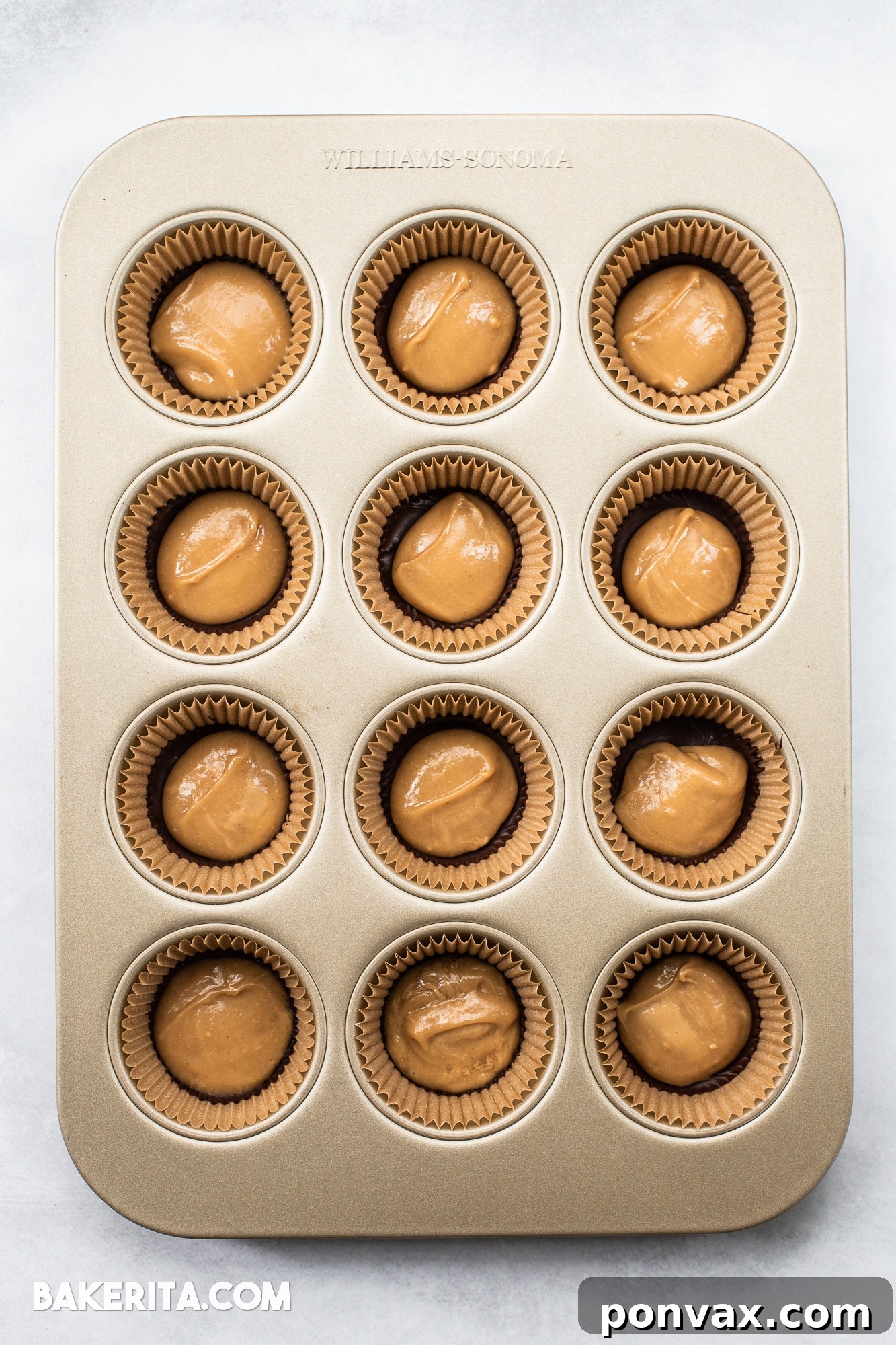 Two halves of Vegan Chocolate Peanut Butter Caramel Cups, showing the rich chocolate shell and the creamy, golden caramel filling.