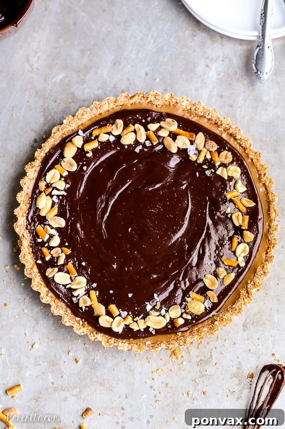 This Chocolate Peanut Butter Tart has a crunchy pretzel crust and smooth peanut butter caramel filling, all topped with luscious chocolate ganache. This recipe is gluten-free and vegan.