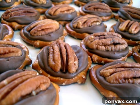 Delicious Pretzel Rolo Turtles arranged on a baking sheet, showcasing their golden pretzels, melted caramel, and nutty tops.