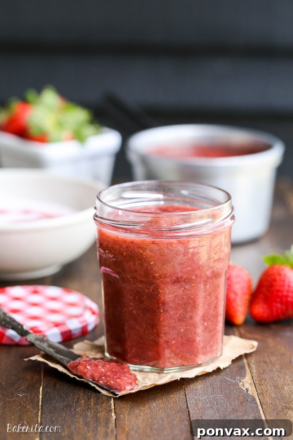 Vibrant Strawberry Rhubarb Chia Jam 4 A close-up shot of homemade Strawberry Rhubarb Chia Jam in a glass jar, highlighting its fresh, vibrant color and healthy ingredients.