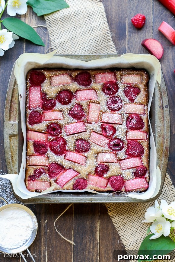 These Raspberry Rhubarb Almond Bars have an crisp almond flour crust topped with soft almond frangipane, fresh raspberries, and tart rhubarb. This recipe is Paleo, gluten free + refined sugar free.