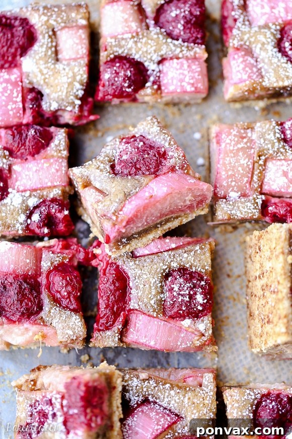 These Raspberry Rhubarb Almond Bars have an crisp almond flour crust topped with soft almond frangipane, fresh raspberries, and tart rhubarb. This recipe is Paleo, gluten free + refined sugar free.