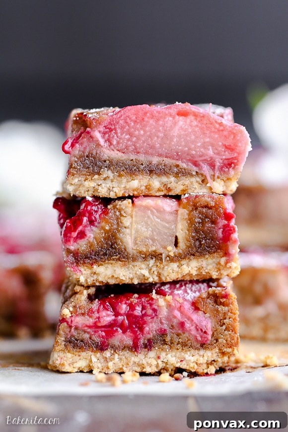These Raspberry Rhubarb Almond Bars have an crisp almond flour crust topped with soft almond frangipane, fresh raspberries, and tart rhubarb. This recipe is Paleo, gluten free + refined sugar free.
