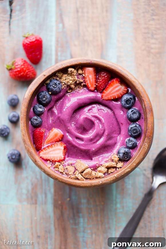 Close-up of a Berry Pitaya Smoothie Bowl with various toppings.