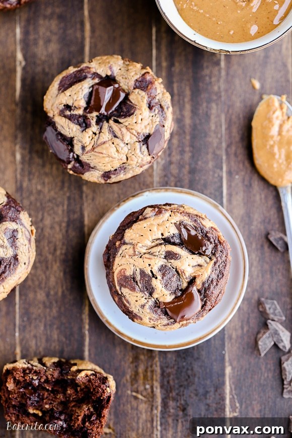 Delicious Chocolate Peanut Butter Banana Muffins loaded with chocolate chunks and a peanut butter swirl, gluten-free and naturally sweetened.