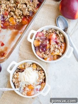This Summer Stone Fruit Crisp features lightly sweetened peaches, plums, and nectarines topped with a oatmeal pecan crumble topping. This gluten-free and vegan dessert showcases the best of summer!