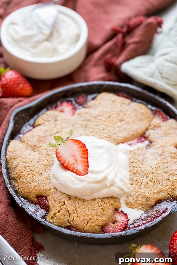 Allergy-Friendly Strawberry Cobbler Dream 3 A close-up of a small batch strawberry cobbler, showing the bubbly fruit filling and golden brown topping.