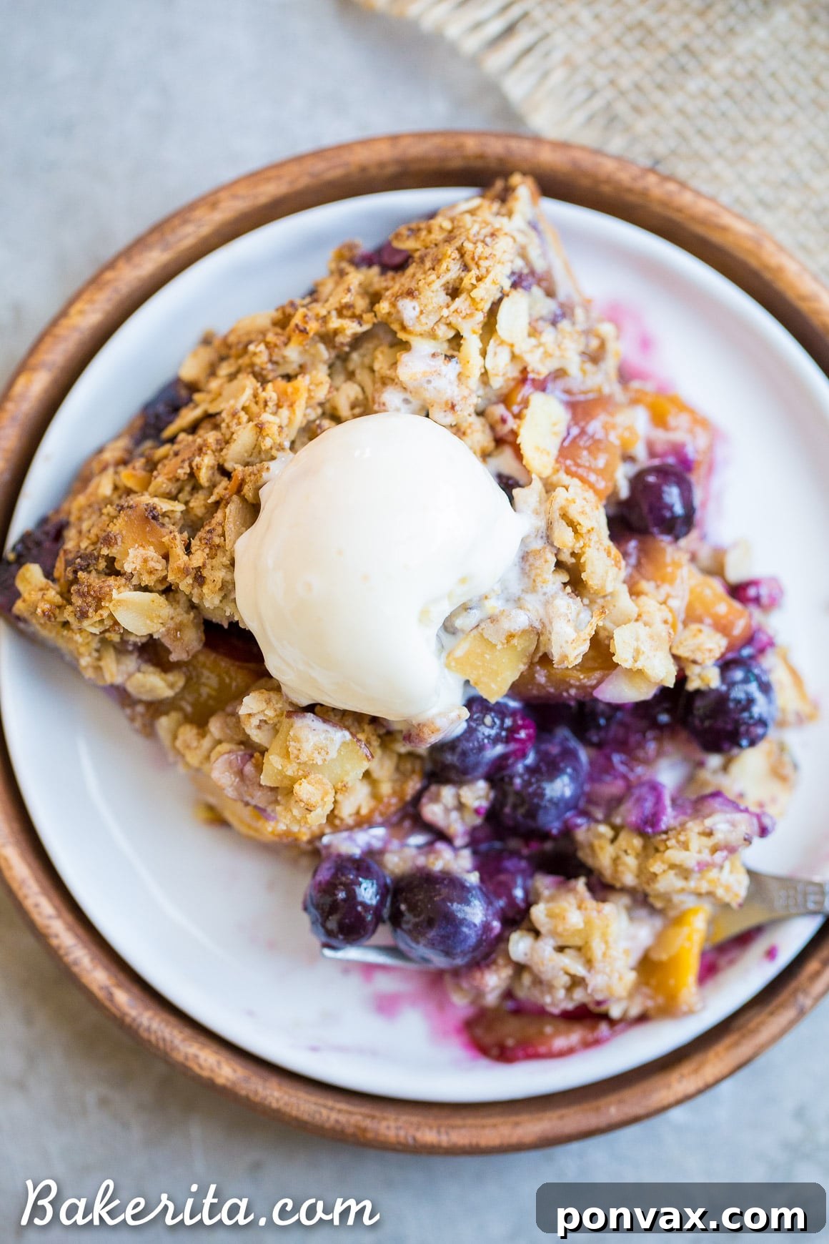 Sweet Freedom Blueberry Nectarine Almond Crumble Pie 5 The golden-brown oatmeal almond crumble topping on a Blueberry Nectarine Pie, offering a delightful crunchy texture.