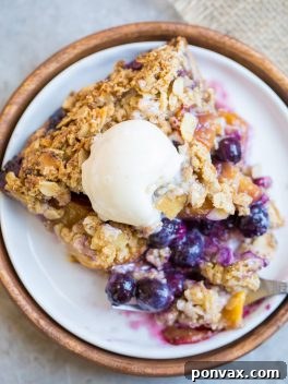 Overhead view of a freshly baked Gluten-Free Blueberry Nectarine Pie, featuring a golden crumble and juicy fruit filling.