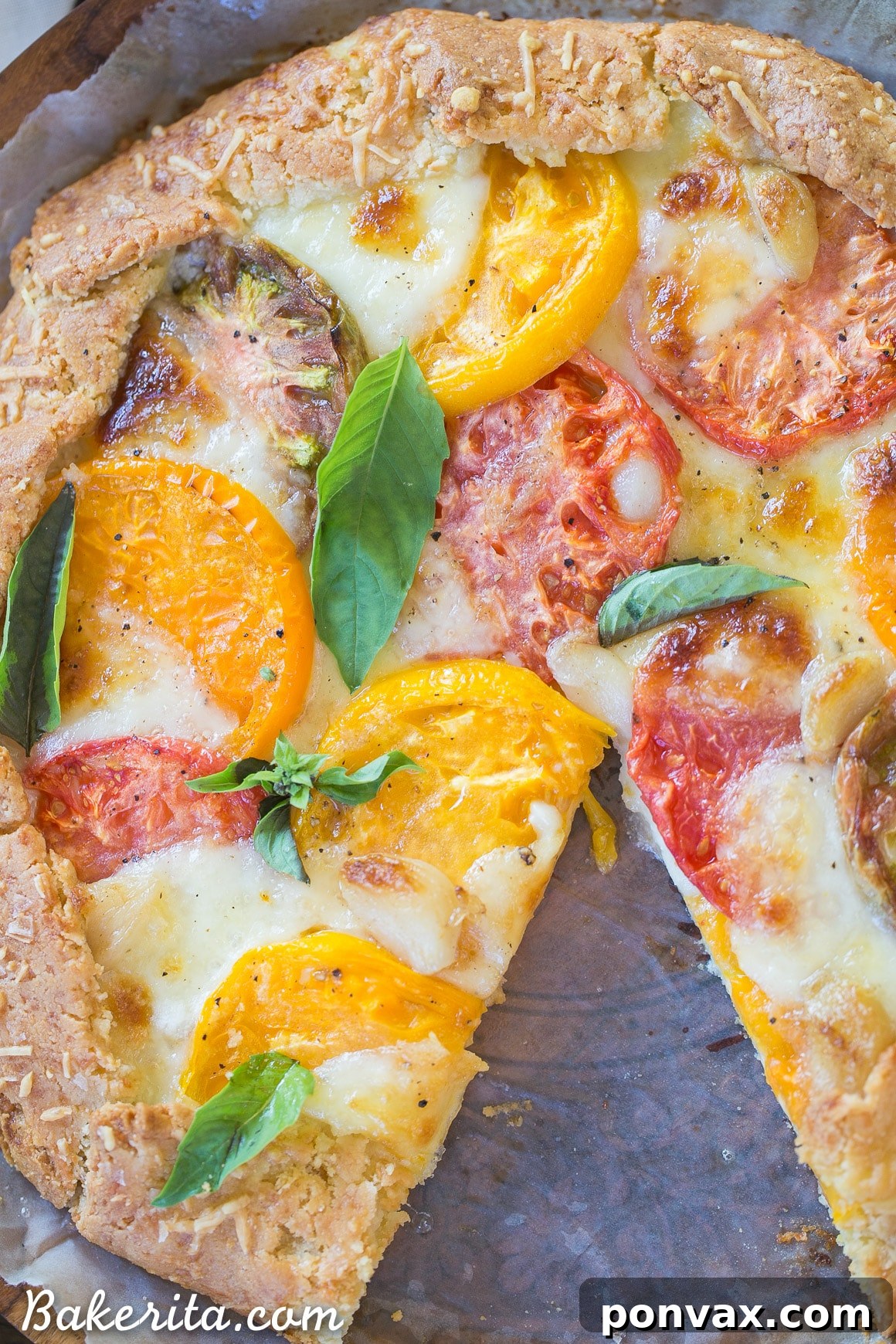 Rustic Gluten-Free Tomato Mozzarella Galette with a Golden Parmesan Crust 6 Overhead view of a Mozzarella Heirloom Tomato Galette, showing the artful arrangement of tomato and mozzarella slices before baking.