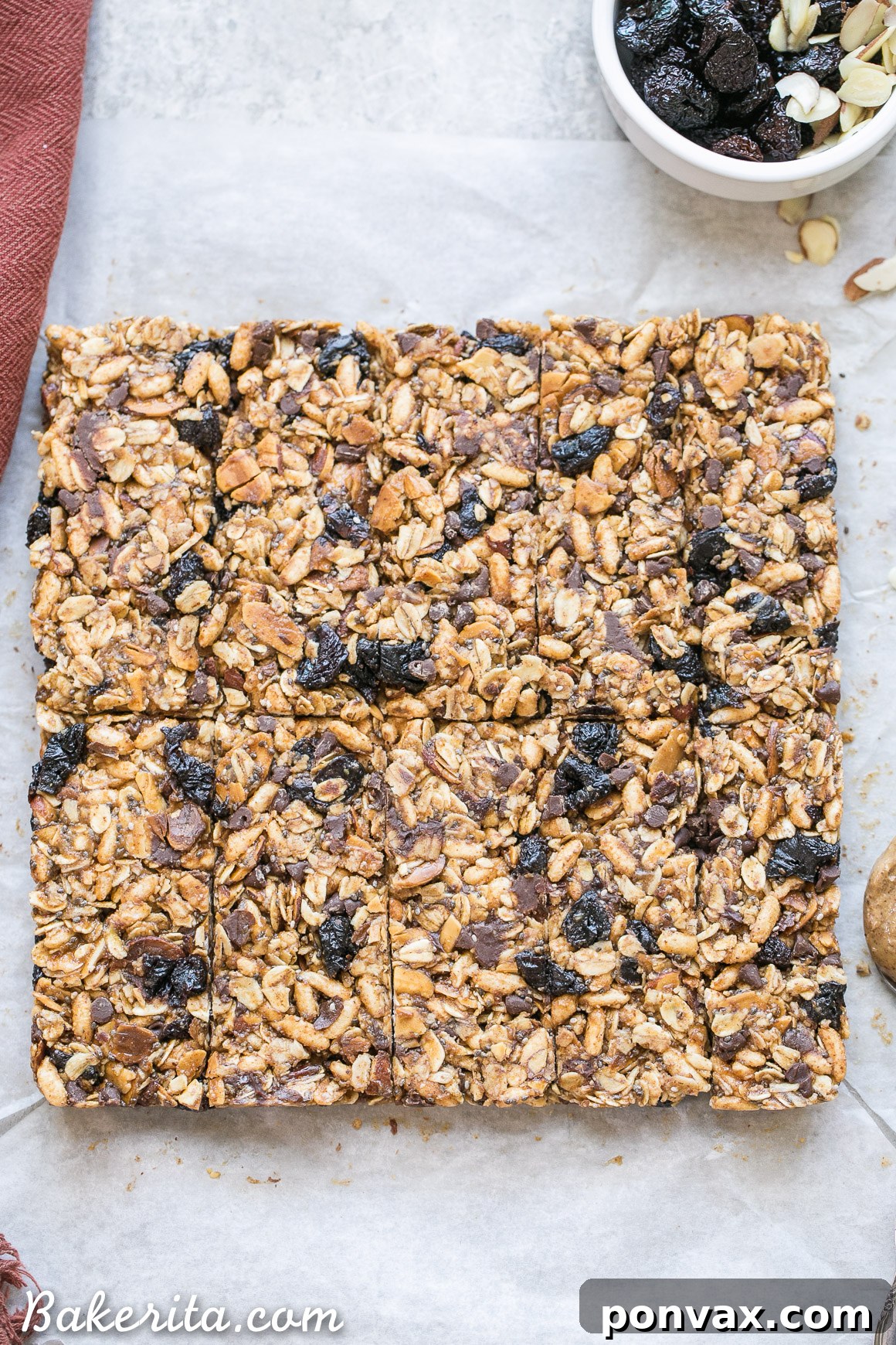 These no bake Dried Cherry, Almond + Chocolate Chip Granola Bars are the perfect grab and go breakfast or snack. These flavor-packed granola bars are gluten free, refined sugar free, vegan, and topped with a dark chocolate drizzle!