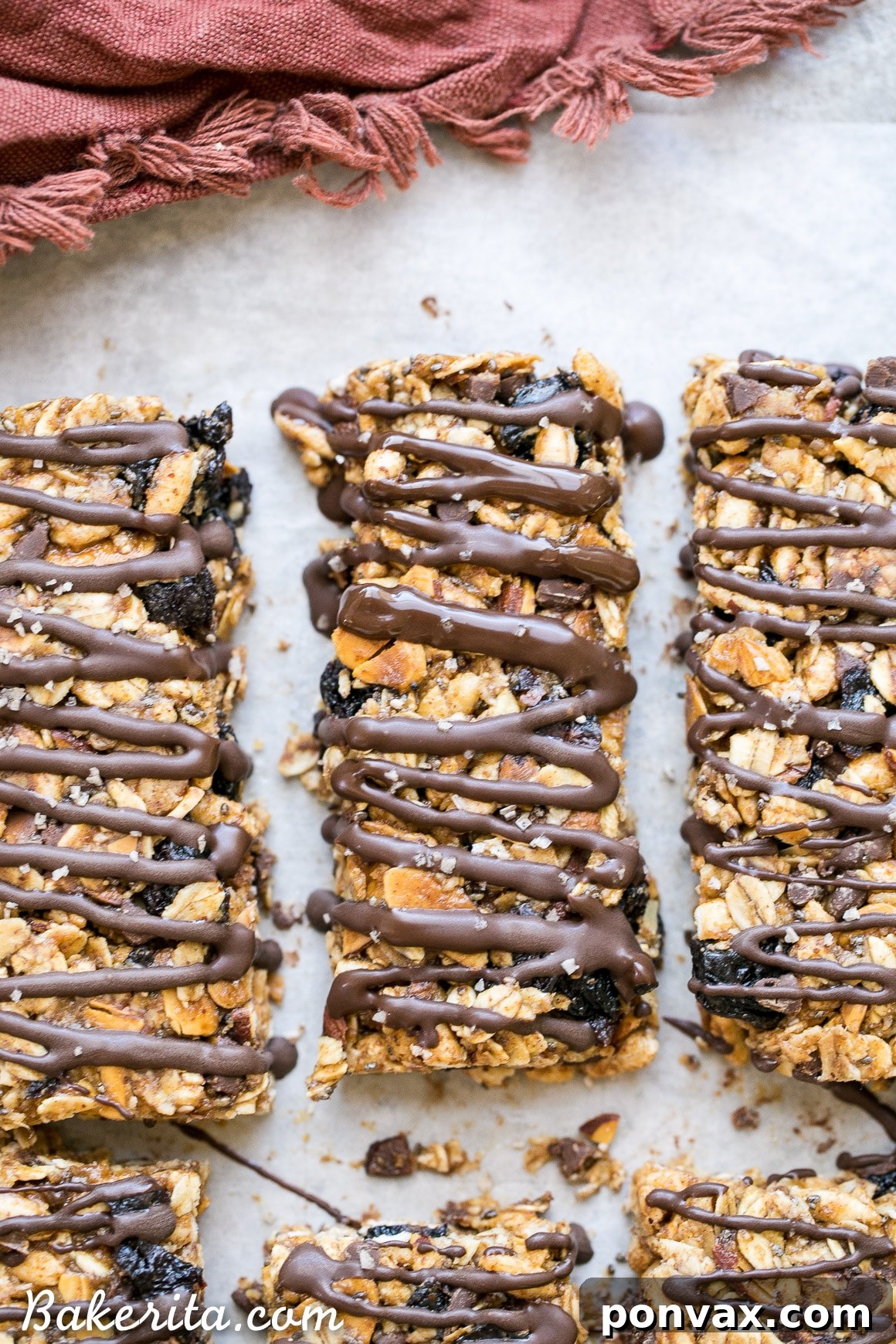 These no bake Dried Cherry, Almond + Chocolate Chip Granola Bars are the perfect grab and go breakfast or snack. These flavor-packed granola bars are gluten free, refined sugar free, vegan, and topped with a dark chocolate drizzle!