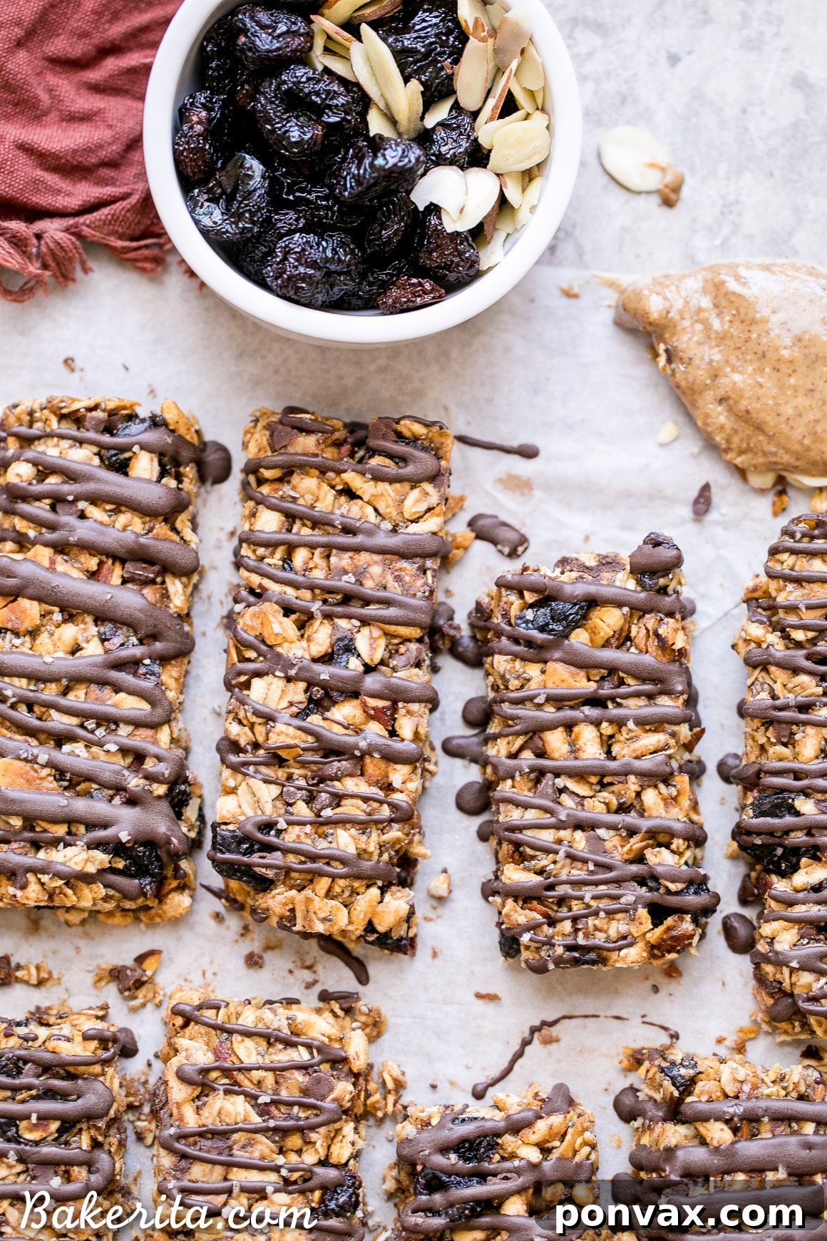 These no bake Dried Cherry, Almond + Chocolate Chip Granola Bars are the perfect grab and go breakfast or snack. These flavor-packed granola bars are gluten free, refined sugar free, vegan, and topped with a dark chocolate drizzle!