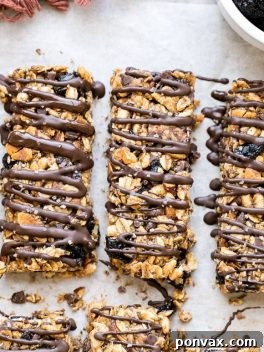 These no bake Dried Cherry, Almond + Chocolate Chip Granola Bars are the perfect grab and go breakfast or snack. These flavor-packed granola bars are gluten free, refined sugar free, vegan, and topped with a dark chocolate drizzle!