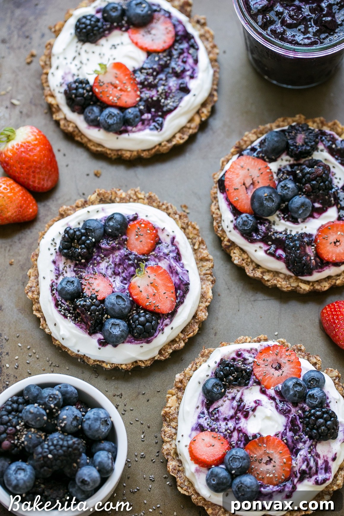 Delicious Granola Crust Breakfast Tarts topped with Greek yogurt and an assortment of fresh berries, highlighting a gluten-free and refined sugar-free breakfast option.