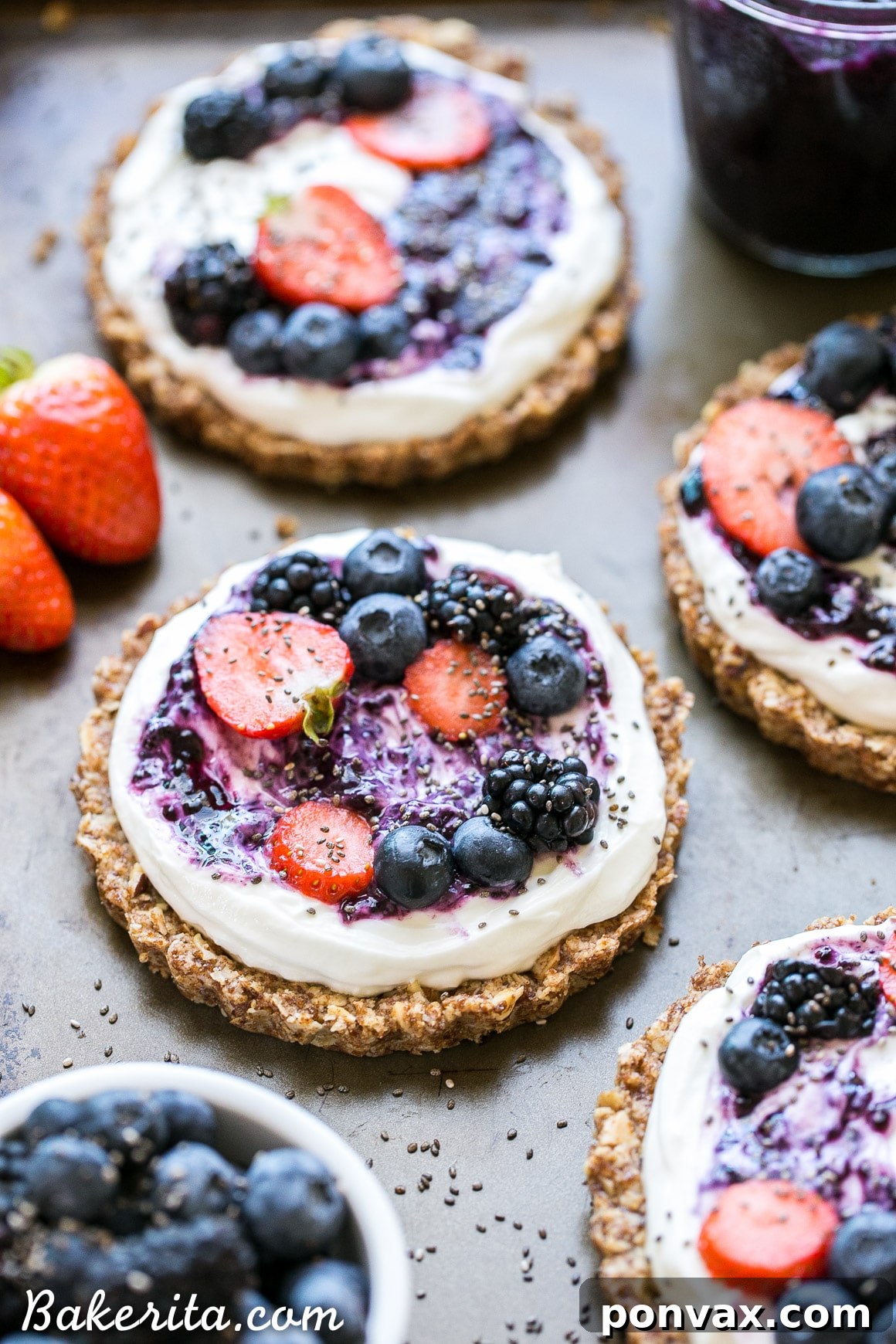 Ingredients for Granola Crust Breakfast Tarts laid out on a table, including oats, nuts, coconut oil, and berries, emphasizing the natural and healthy components.