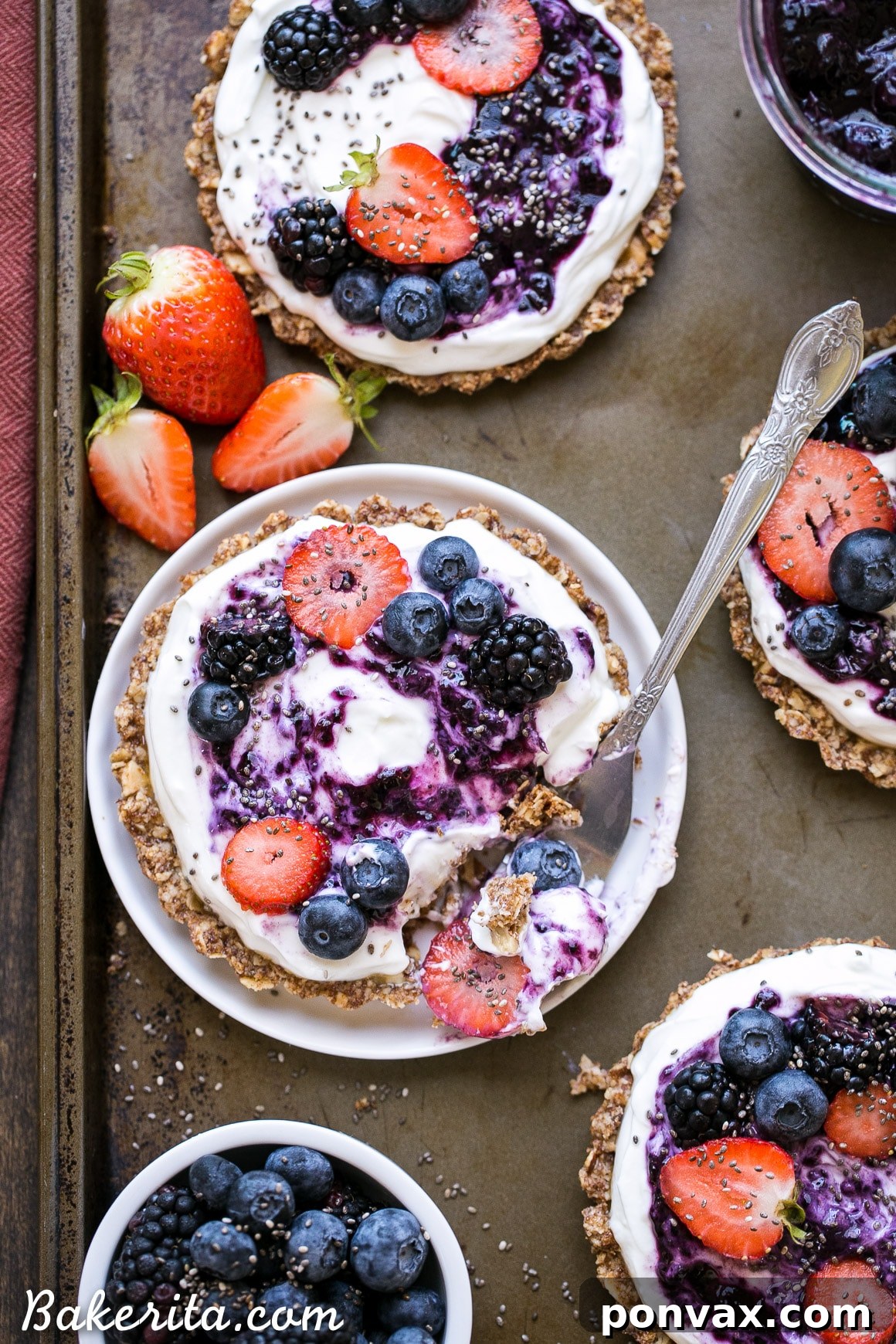 Baked granola crusts for breakfast tarts cooling on a wire rack, ready for the yogurt and berry toppings, showcasing the perfect golden brown texture.