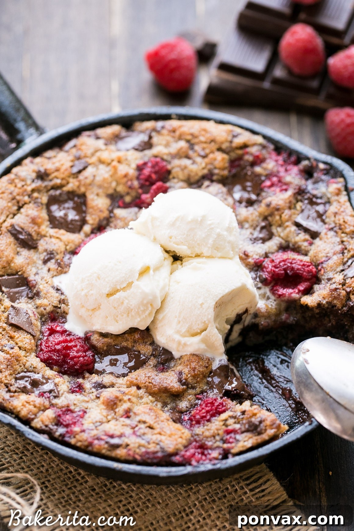 A close-up shot of the Skillet Cookie with a scoop of melting vanilla ice cream on top, creating a delightful hot and cold dessert.