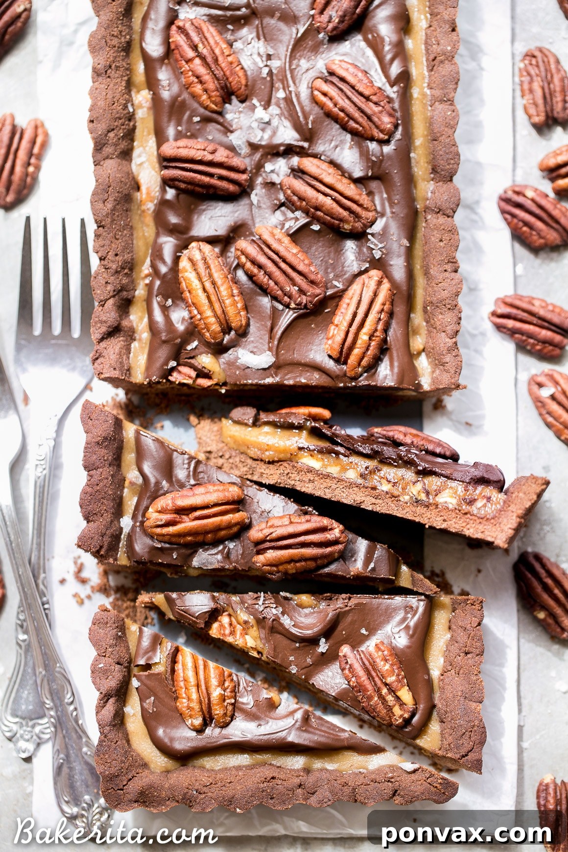 Indulgent Paleo Vegan Gluten Free Chocolate Pecan Tart 6 A top-down view of a single slice of Chocolate Pecan Tart, revealing the layers of chocolate crust, pecan caramel, and ganache. A perfect example of a gluten-free, Paleo, and vegan dessert.