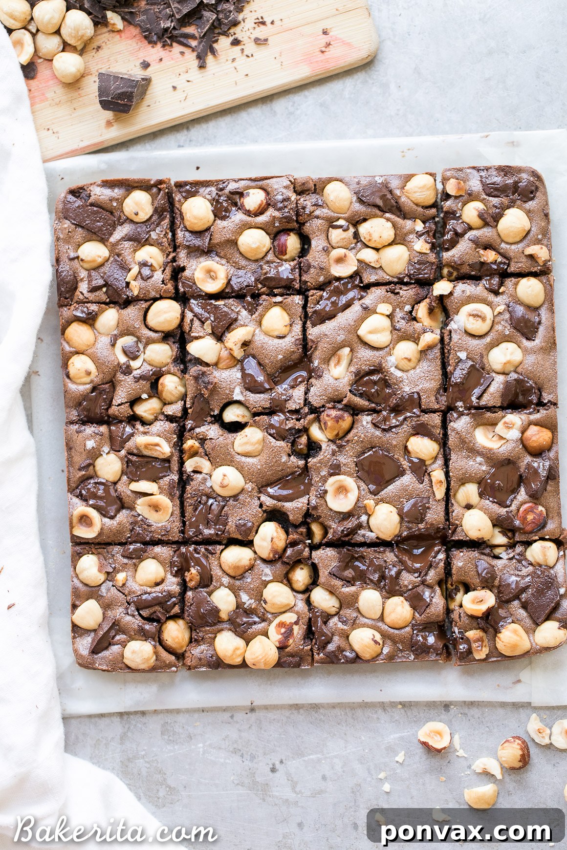 Detailed close-up of the textured surface of a Chocolate Hazelnut Bar, showcasing the embedded dark chocolate chunks and whole hazelnuts against the rich chocolate filling.