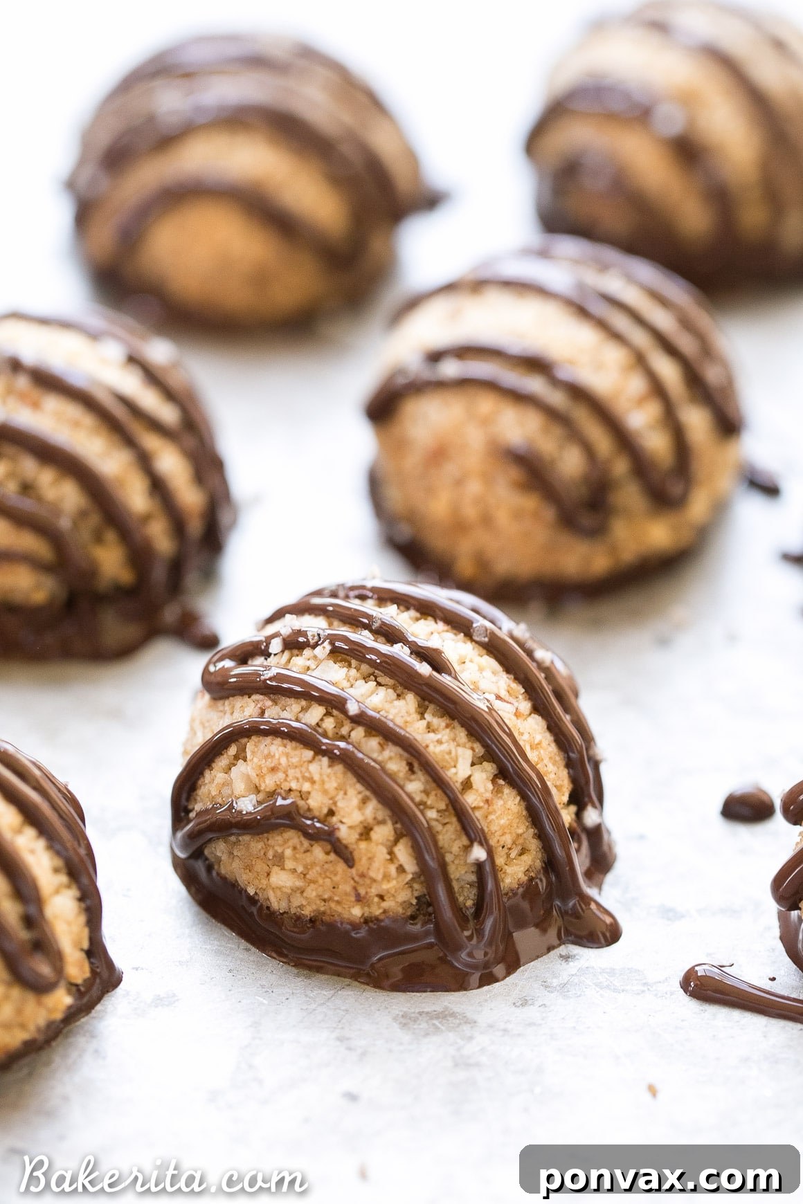 Another enticing view of golden-brown vanilla bean macaroons cooling on a wire rack.