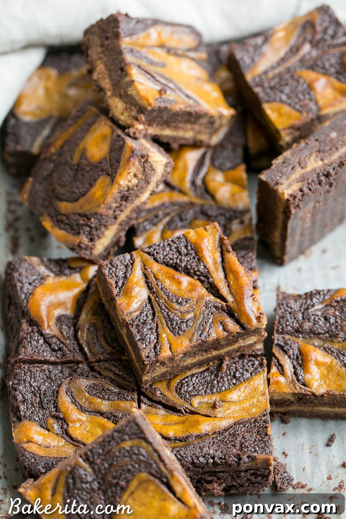 These Pumpkin Cheesecake Brownies are moist + fudgy brownies with a swirled layer of spiced pumpkin cheesecake! These brownies are gluten-free and refined sugar free.