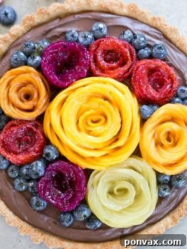 The ultimate Vegan Chocolate Mousse Tart with Coconut Crust and Fresh Fruit Flowers, a gluten-free and Paleo friendly dessert.